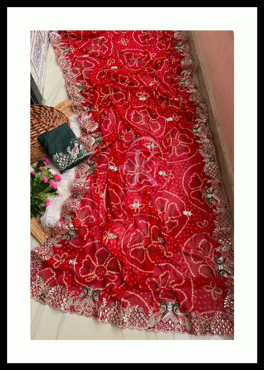 Red Bandhani Georgette Saree With Gota Patti Work 4 A beautiful red Bandhani georgette saree with intricate gota patti work paired with a contrast green blouse on a textured background.