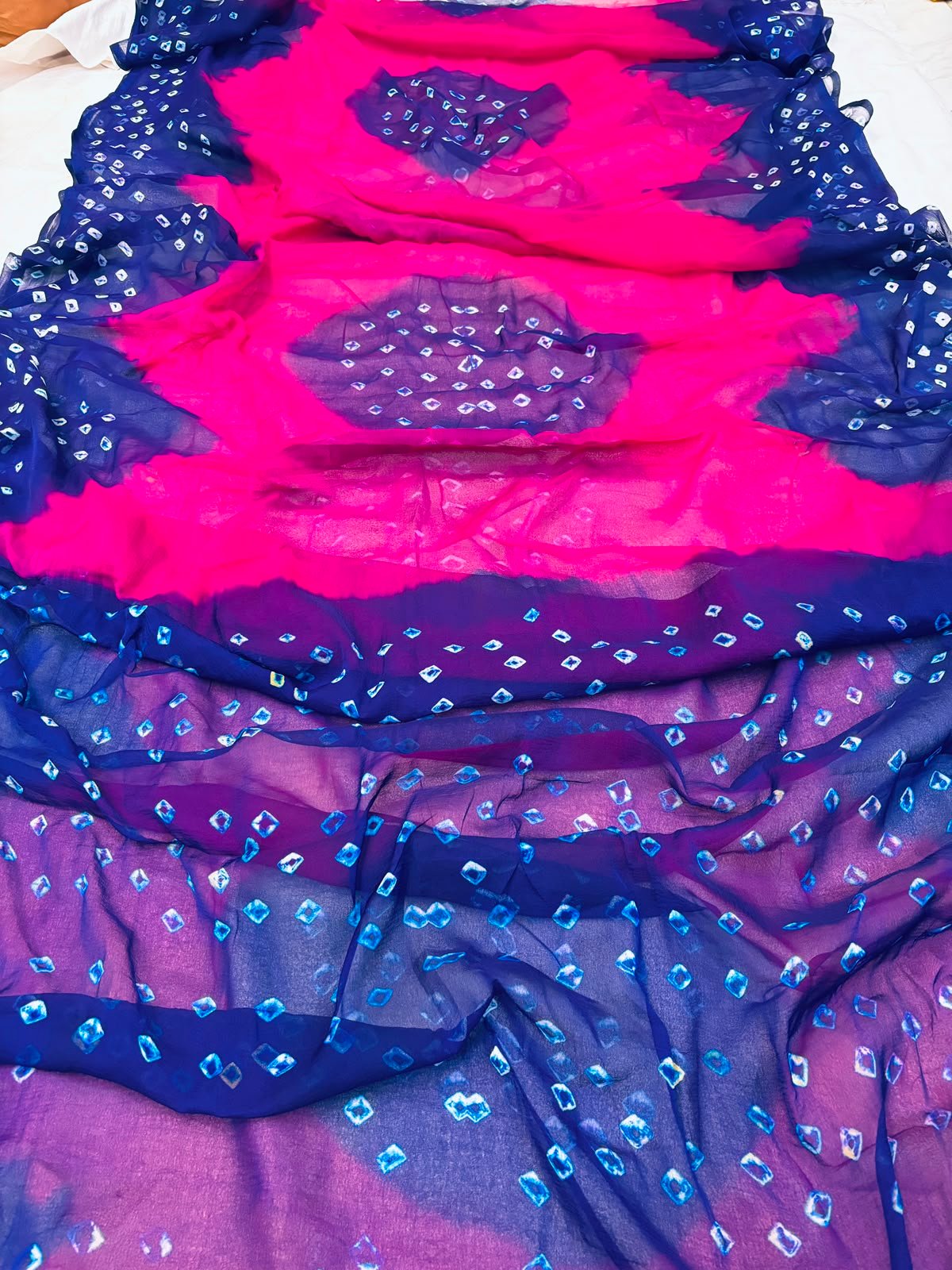 Nazneen Chiffon Hand Tie Dye Bandhani Saree 3 A close-up of a Nazneen Chiffon saree featuring a striking hand tie dye Bandhani pattern in yellow and maroon.