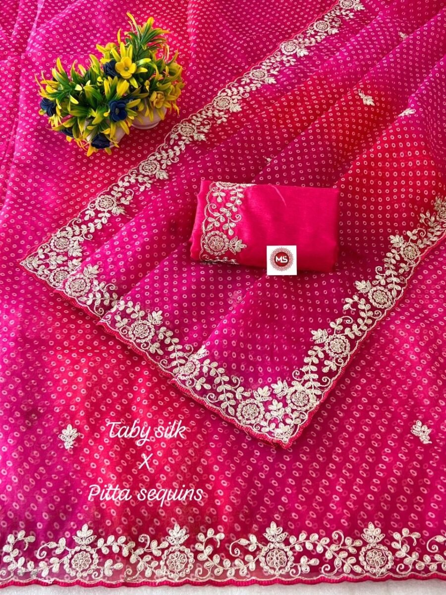 A beautiful pink Bandhani Taby silk saree with intricate gold pitta work borders and a matching blouse.