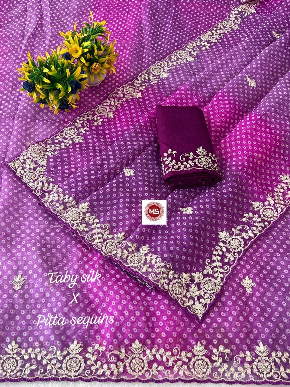 Pink Bandhani Taby Silk Saree with Pitta Work 2 A beautiful pink Bandhani Taby silk saree with intricate gold pitta work borders and a matching blouse.