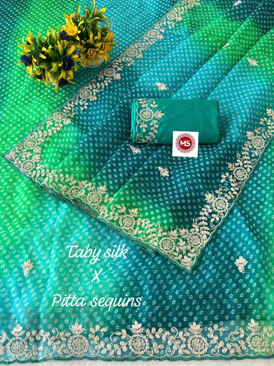 Pink Bandhani Taby Silk Saree with Pitta Work 3 A beautiful pink Bandhani Taby silk saree with intricate gold pitta work borders and a matching blouse.