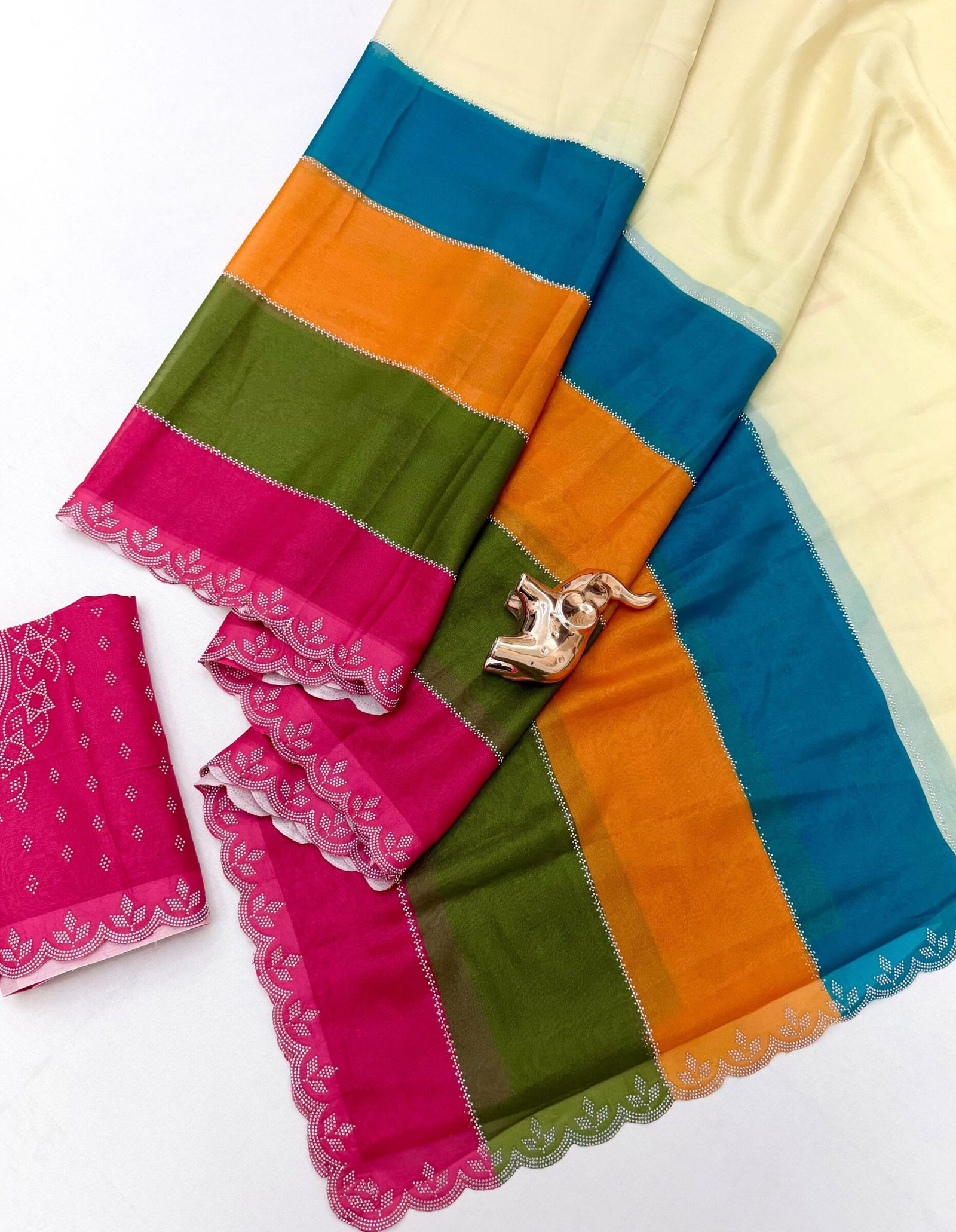 Diamond Panel Work Rich Silk Saree with Fancy Cut Work 2 A colorful multi-paneled silk saree with a silver diamond-studded cut-work border, displayed with a matching blouse piece and a small decorative elephant figurine.