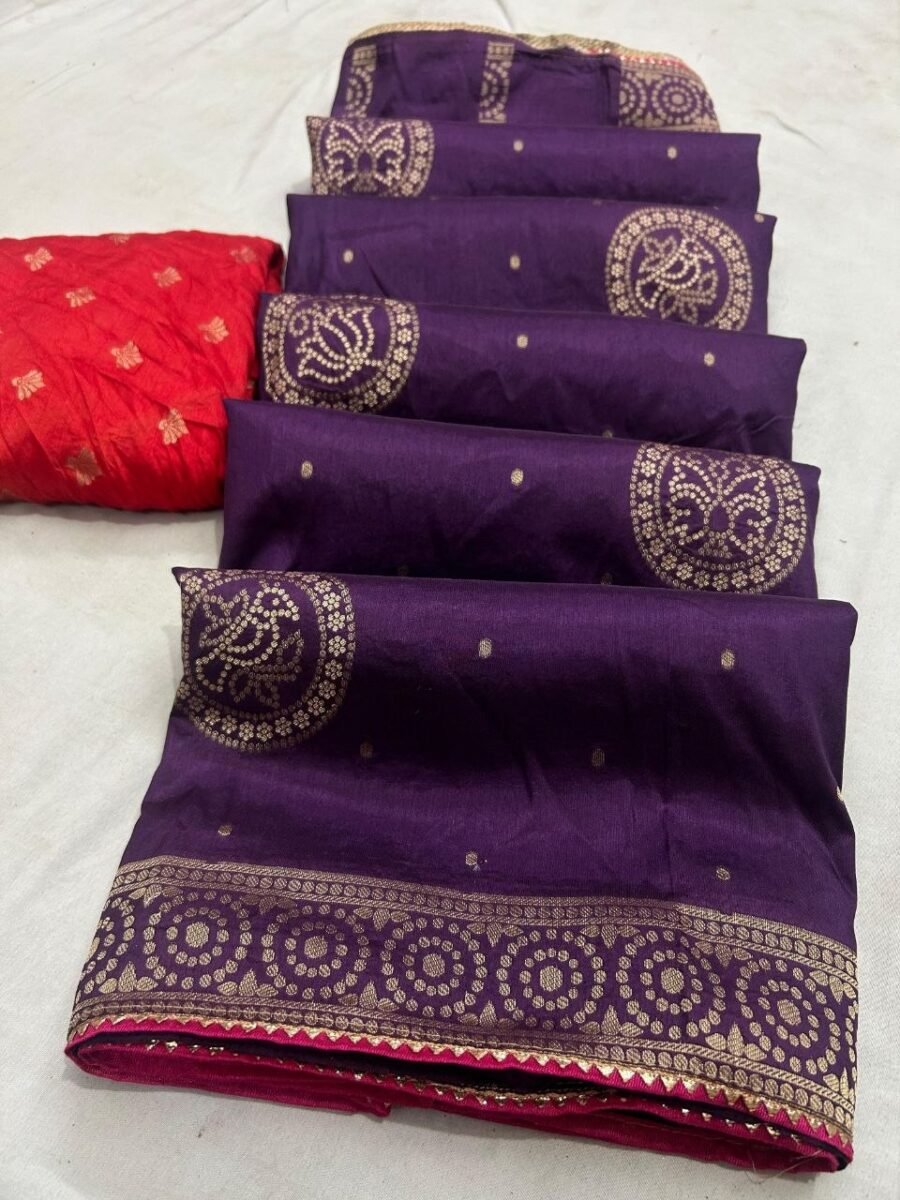A flat-lay view of a deep purple Dola silk saree featuring gold zari work and a contrasting red blouse piece.