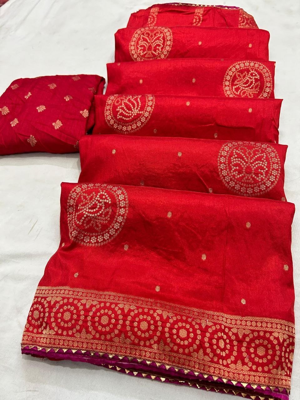 Deep Purple Dola Silk Zari Work Saree | Kanha Saree 5 A flat-lay view of a deep purple Dola silk saree featuring gold zari work and a contrasting red blouse piece.