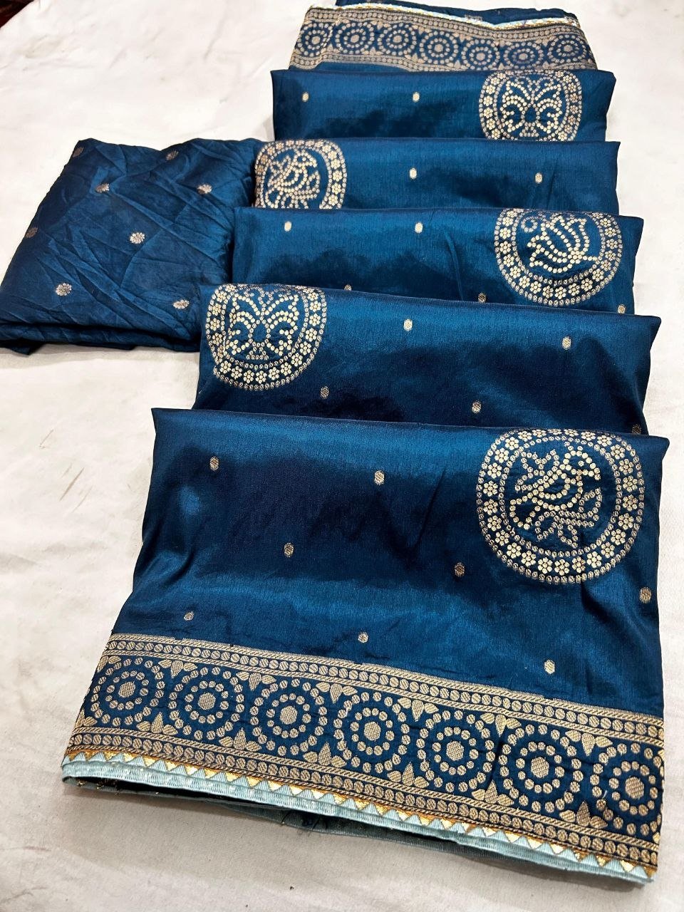 Deep Purple Dola Silk Zari Work Saree | Kanha Saree 7 A flat-lay view of a deep purple Dola silk saree featuring gold zari work and a contrasting red blouse piece.