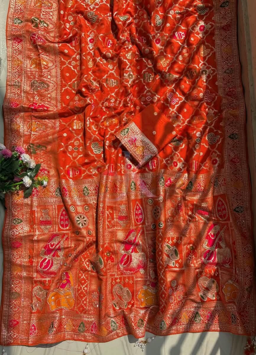A vibrant red and rani Dola Viscose saree with intricate Meenakari weaving, heavy Jarkhan work, and a rich decorative pallu.
