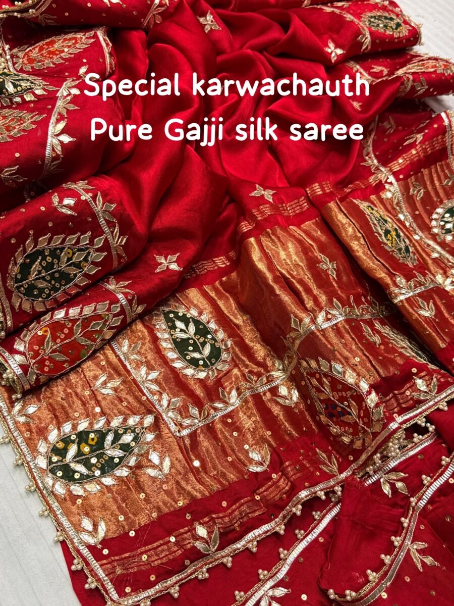 A close-up view of a vibrant red pure Gajji Silk saree featuring detailed hand Gota Patti Keri work and a decorative designer border.