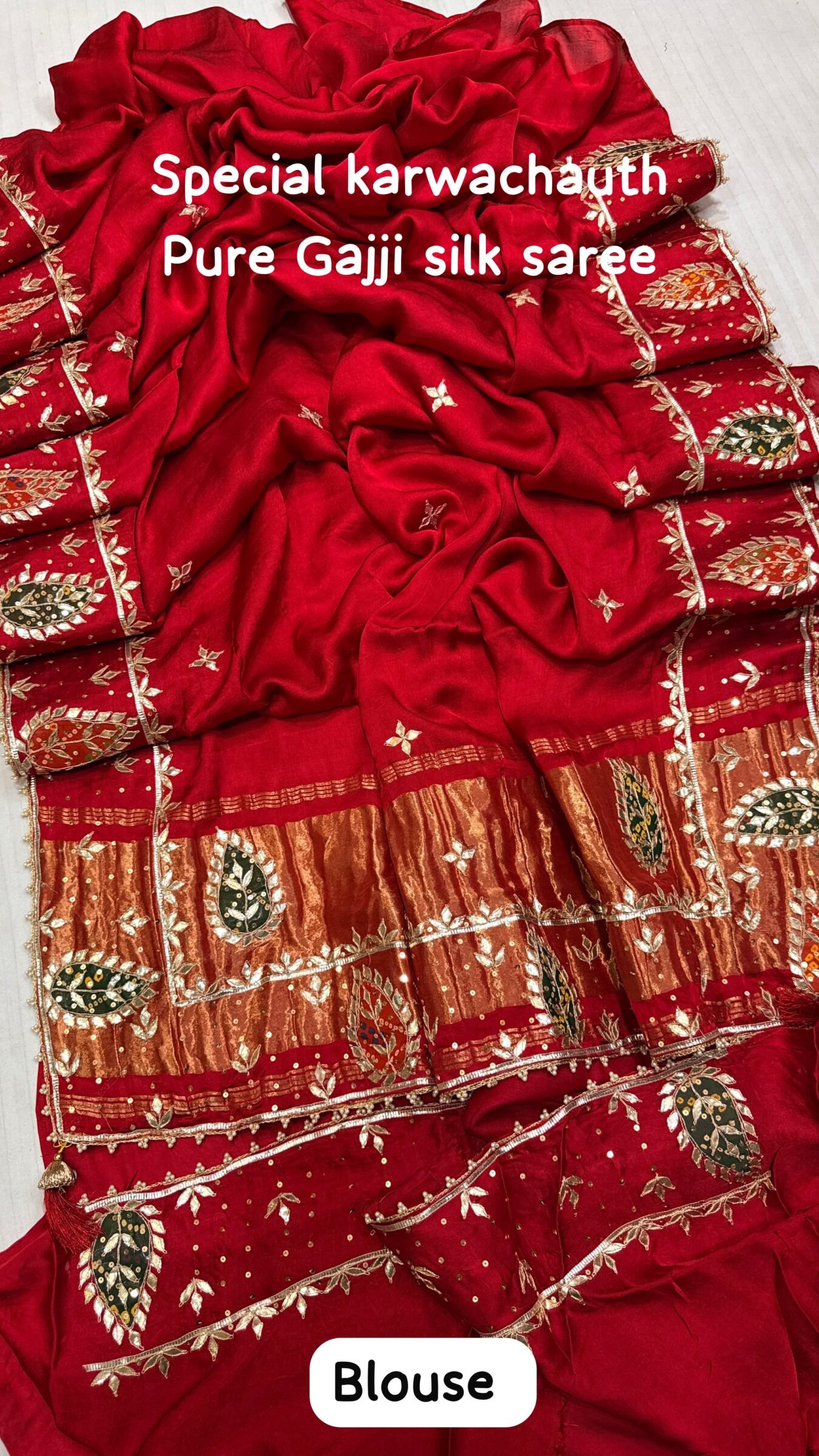 Pure Gajji Silk Saree with Hand Gota Patti Work 2 A close-up view of a vibrant red pure Gajji Silk saree featuring detailed hand Gota Patti Keri work and a decorative designer border.