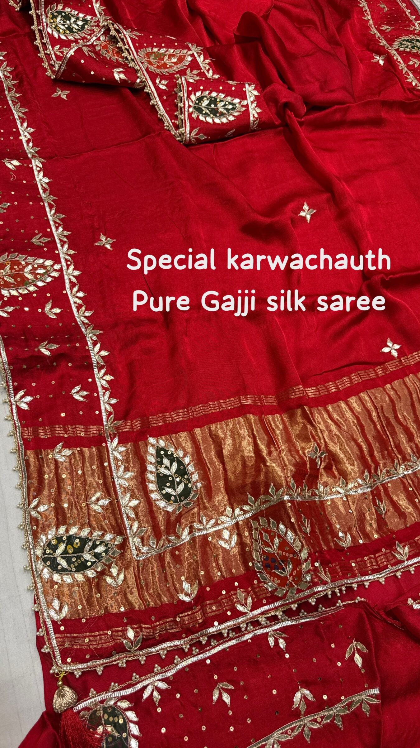 Pure Gajji Silk Saree with Hand Gota Patti Work 4 A close-up view of a vibrant red pure Gajji Silk saree featuring detailed hand Gota Patti Keri work and a decorative designer border.