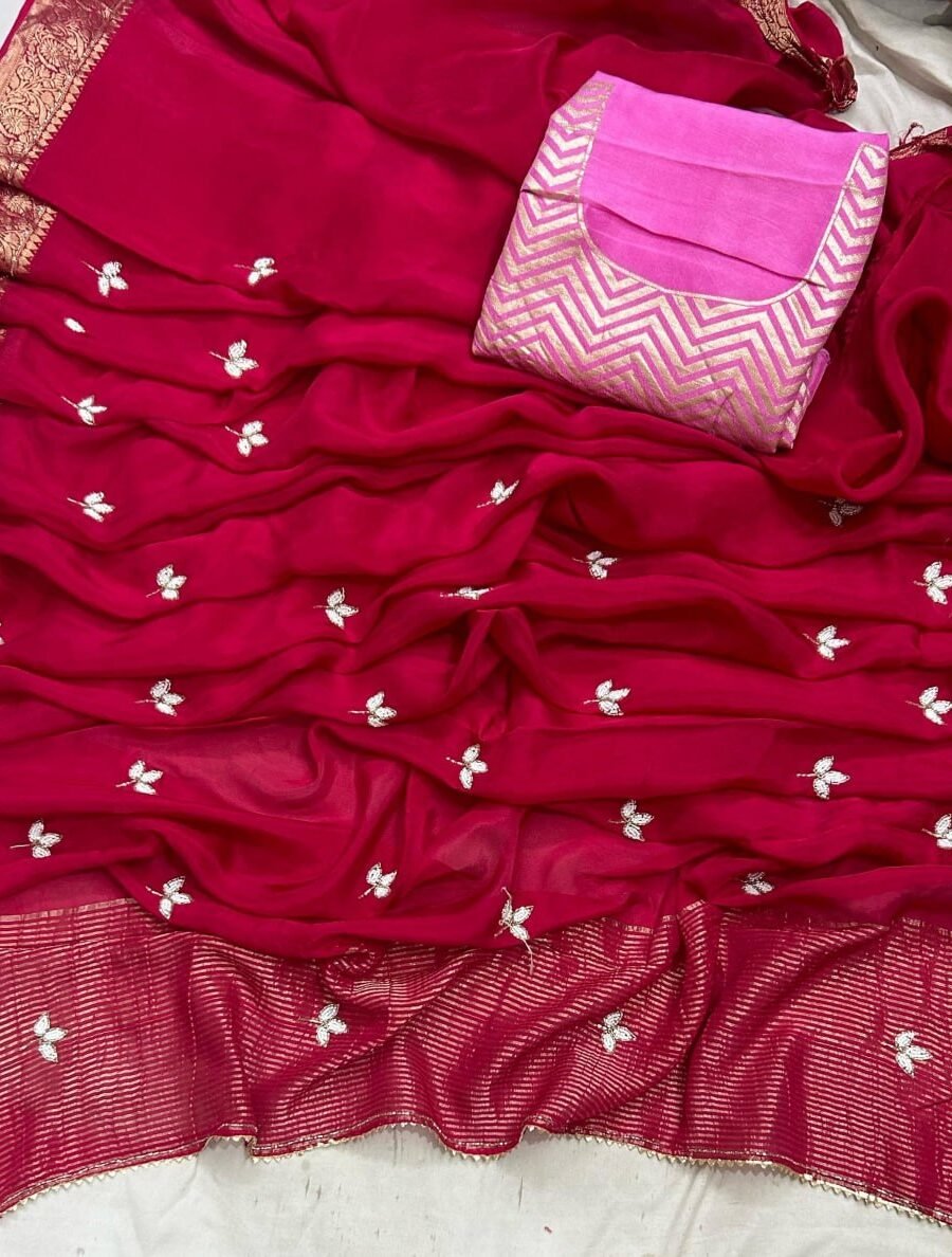 A luxurious H.O. Silk saree in a deep red shade with intricate embroidery and a traditional zari border.