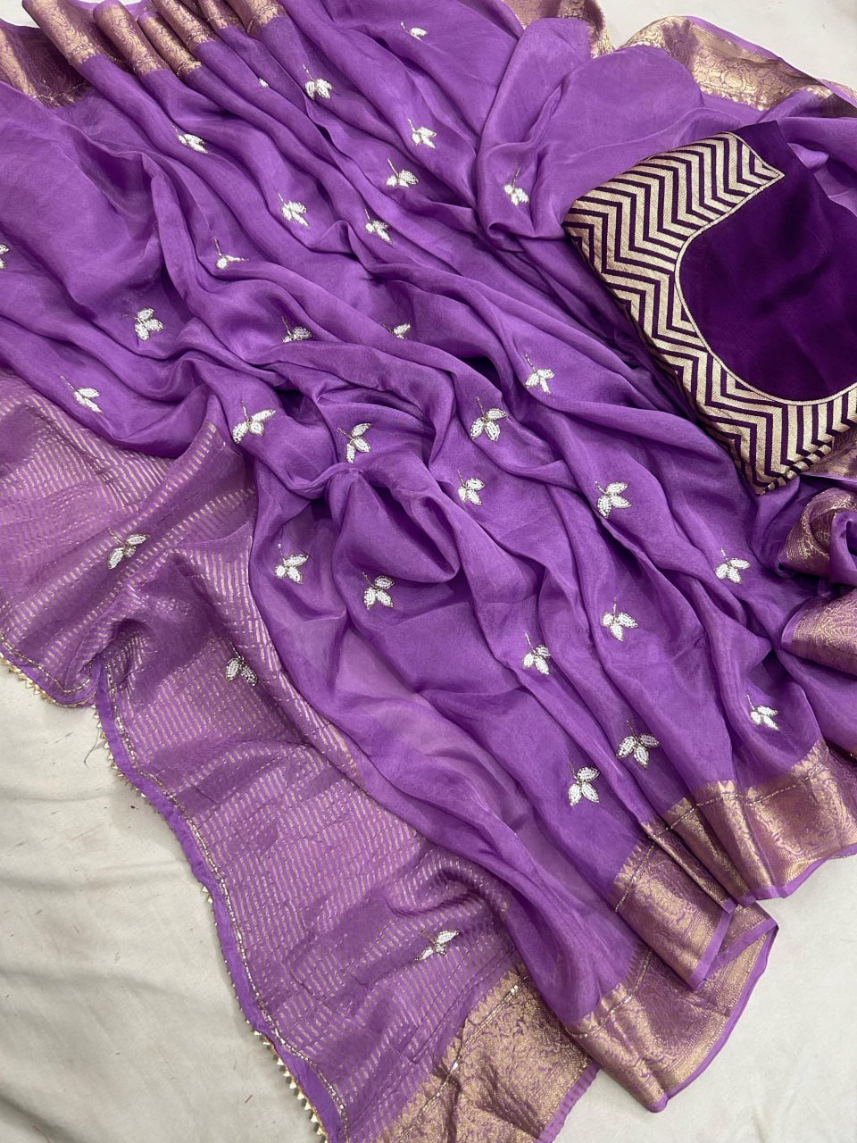 H.O. Silk Saree with Elegant Zari Border 2 A luxurious H.O. Silk saree in a deep red shade with intricate embroidery and a traditional zari border.