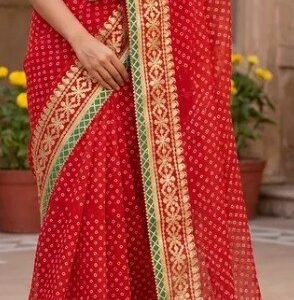 A woman wearing a vibrant red Kota Doriya saree featuring elaborate Gota Patti embroidery and a contrast zigzag border.