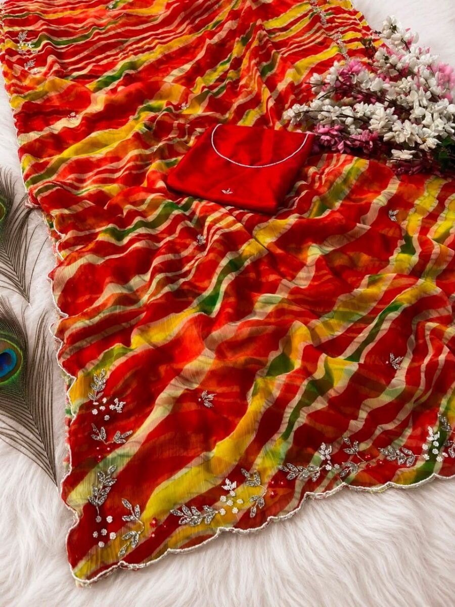 A beautiful chiffon Leheriya saree with handwork, moti accents, and a heavy mono blouse displayed with a peacock feather.