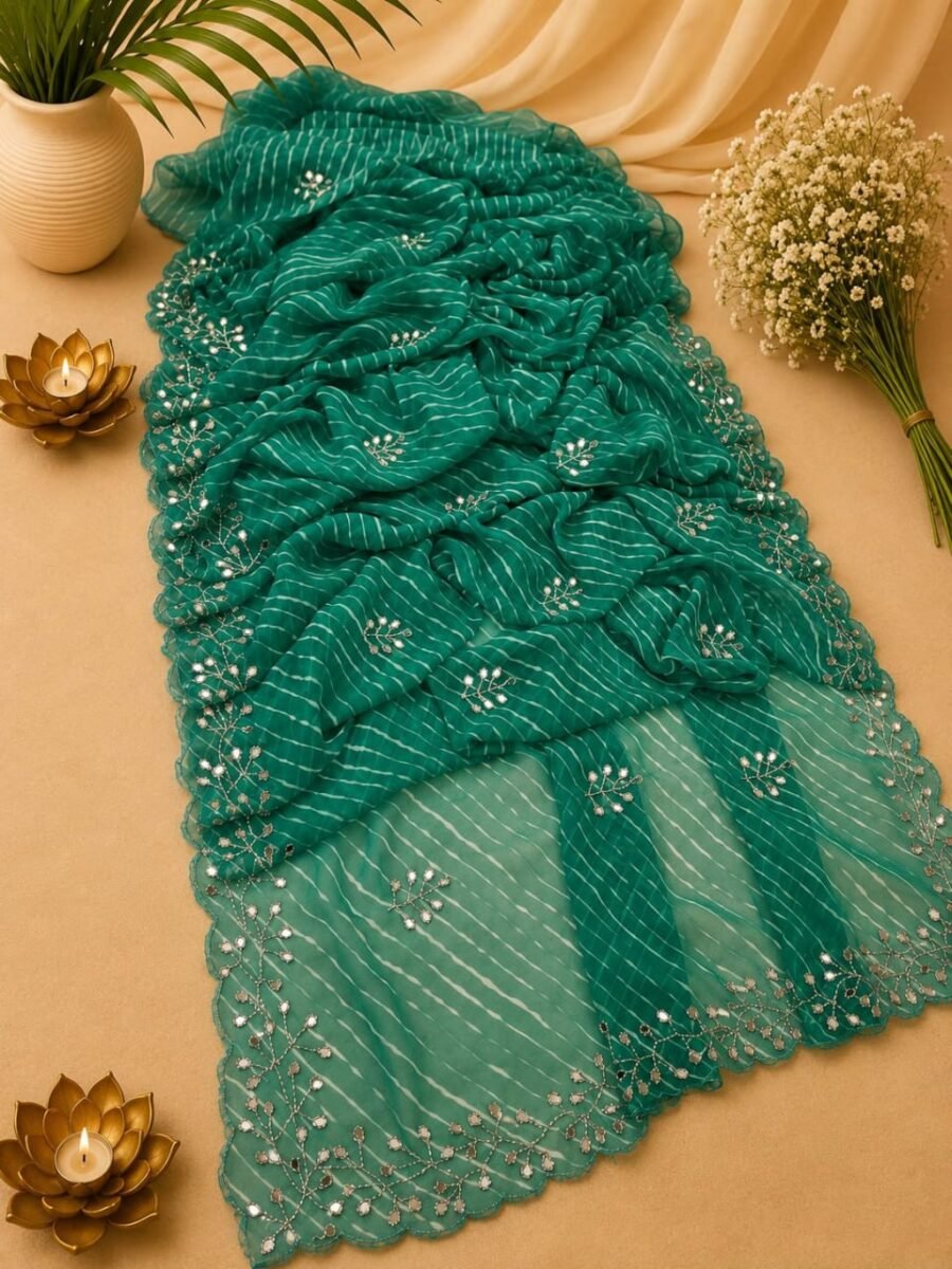 A beautiful multi-colored Leheriya Georgette Saree displayed with mirror work and a cut work border, accompanied by floral accents and candles.