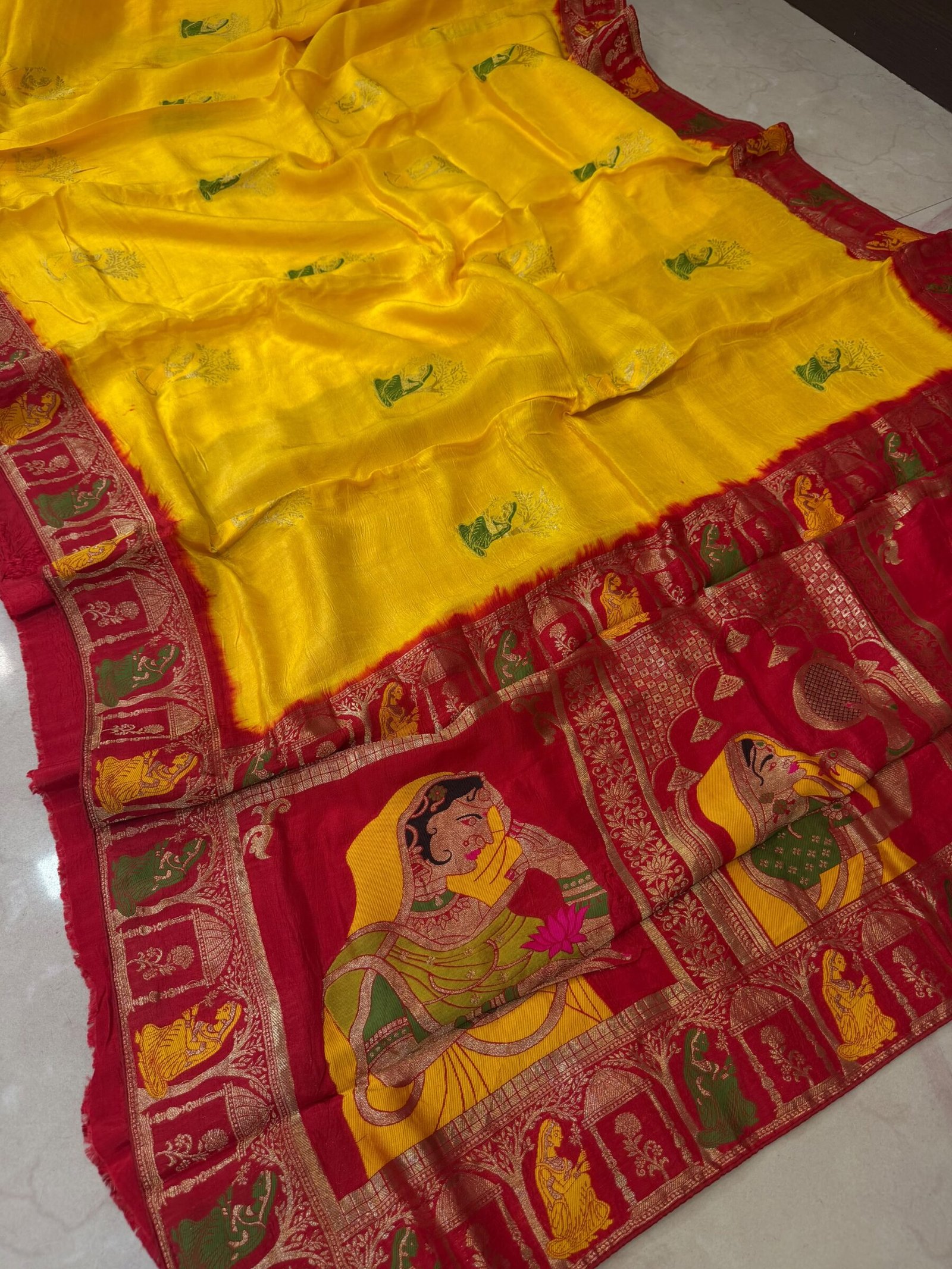 Pure Moonga Silk Banarasi Saree for Karwa Chauth 1 A beautiful bright yellow pure moonga silk banarasi saree with a contrasting red border featuring detailed traditional weaving work.
