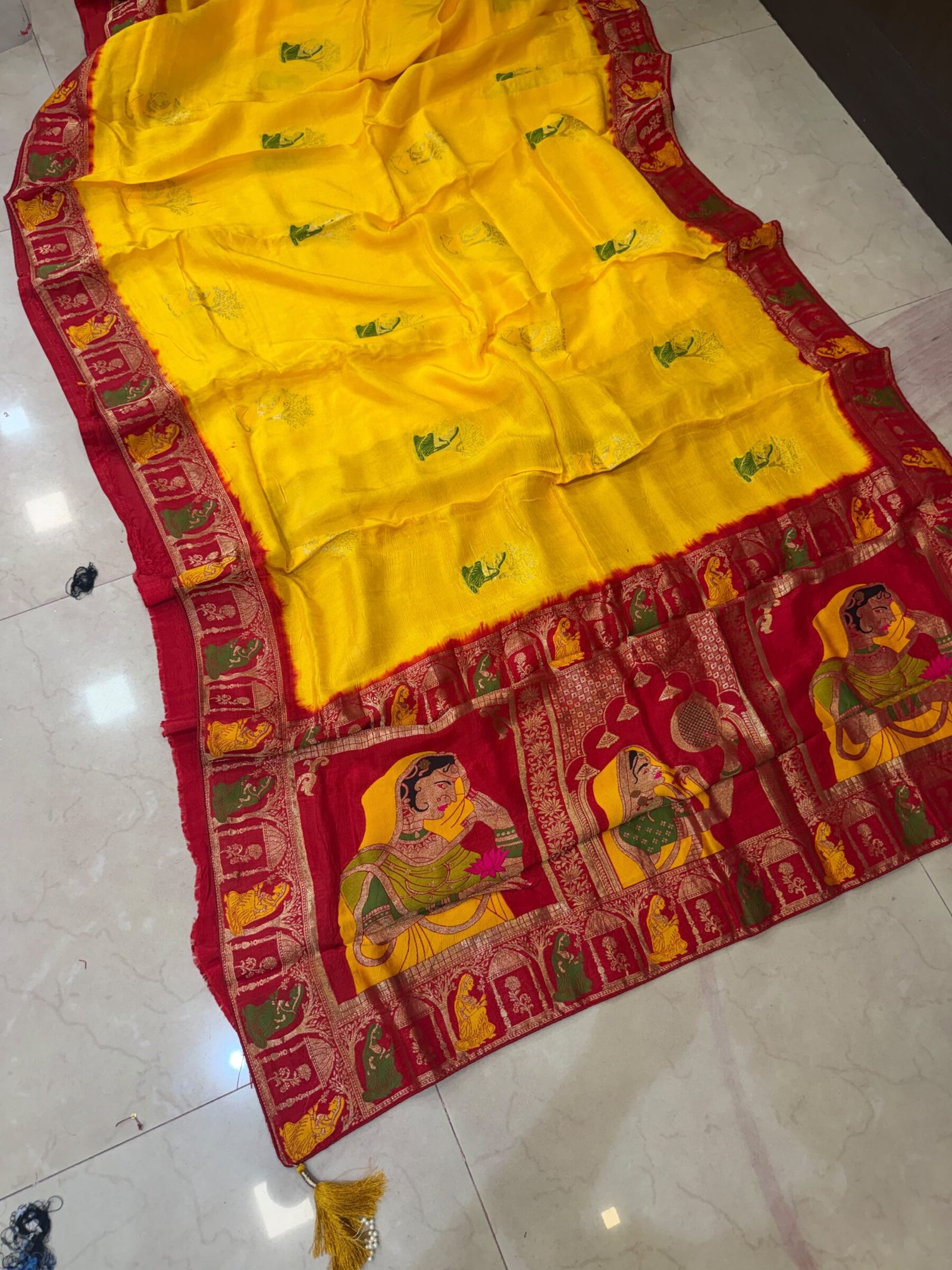 Pure Moonga Silk Banarasi Saree for Karwa Chauth 2 A beautiful bright yellow pure moonga silk banarasi saree with a contrasting red border featuring detailed traditional weaving work.