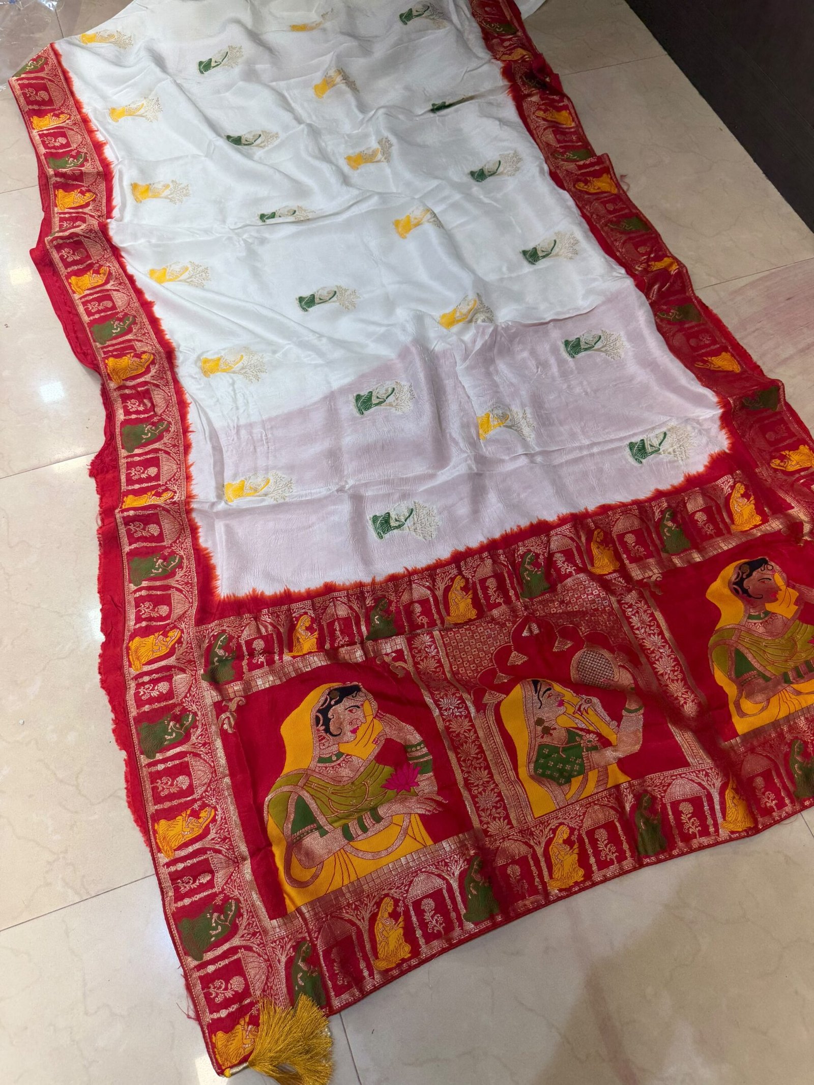 Pure Moonga Silk Banarasi Saree for Karwa Chauth 3 A beautiful bright yellow pure moonga silk banarasi saree with a contrasting red border featuring detailed traditional weaving work.