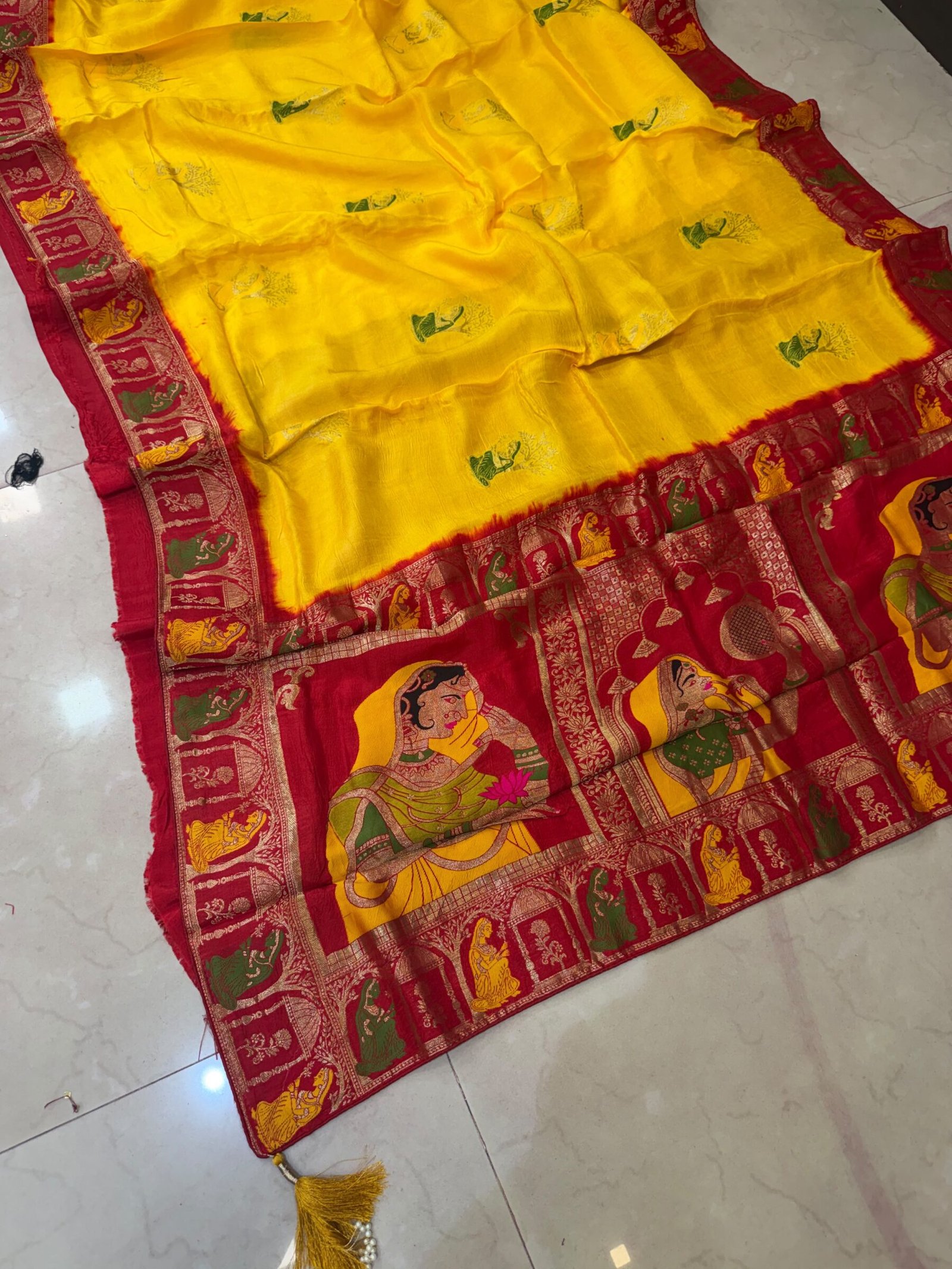 Pure Moonga Silk Banarasi Saree for Karwa Chauth 5 A beautiful bright yellow pure moonga silk banarasi saree with a contrasting red border featuring detailed traditional weaving work.
