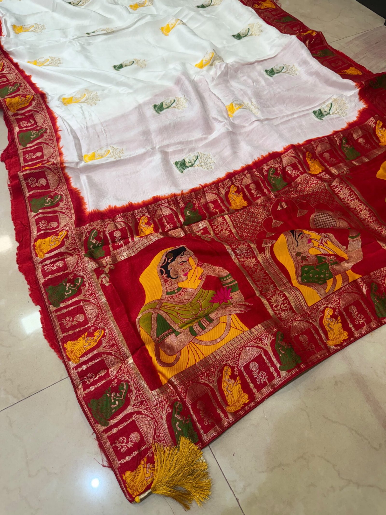 Pure Moonga Silk Banarasi Saree for Karwa Chauth 6 A beautiful bright yellow pure moonga silk banarasi saree with a contrasting red border featuring detailed traditional weaving work.