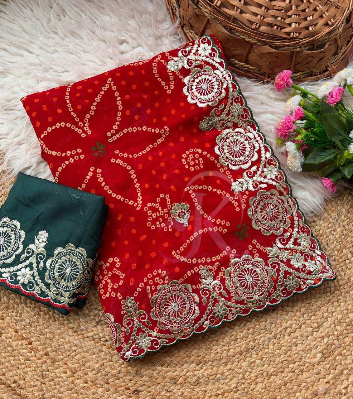 Red Bandhani Saree with Gota Patti Work 1 A vibrant red Bandhani saree with intricate gold Gota Patti border work paired with a dark green embroidered blouse.