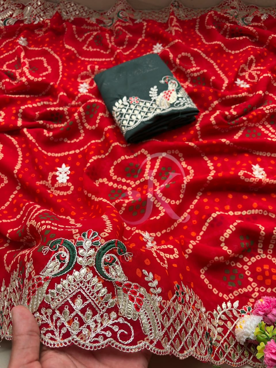 Red Bandhani Saree with Gota Patti Work 4 A vibrant red Bandhani saree with intricate gold Gota Patti border work paired with a dark green embroidered blouse.