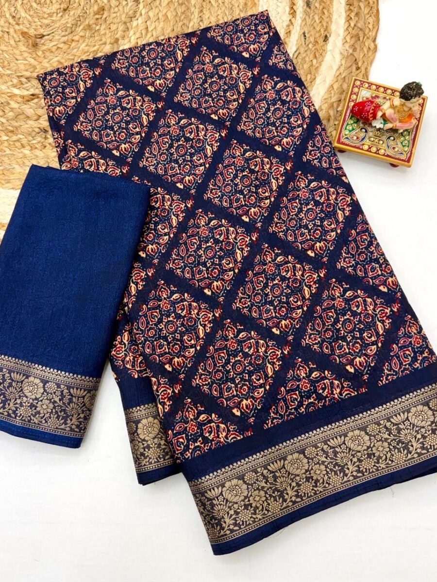 A navy blue Soft Dola weaving saree with an intricate golden jacquard border and a matching blouse piece on a jute mat.