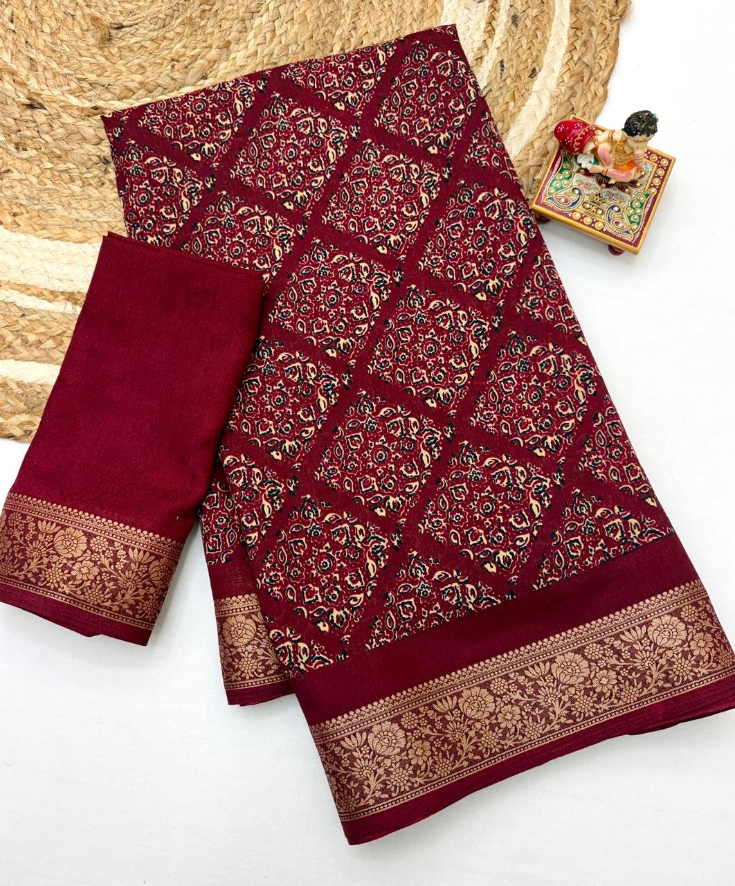Soft Dola Weaving Saree with Jacquard Border 2 A navy blue Soft Dola weaving saree with an intricate golden jacquard border and a matching blouse piece on a jute mat.
