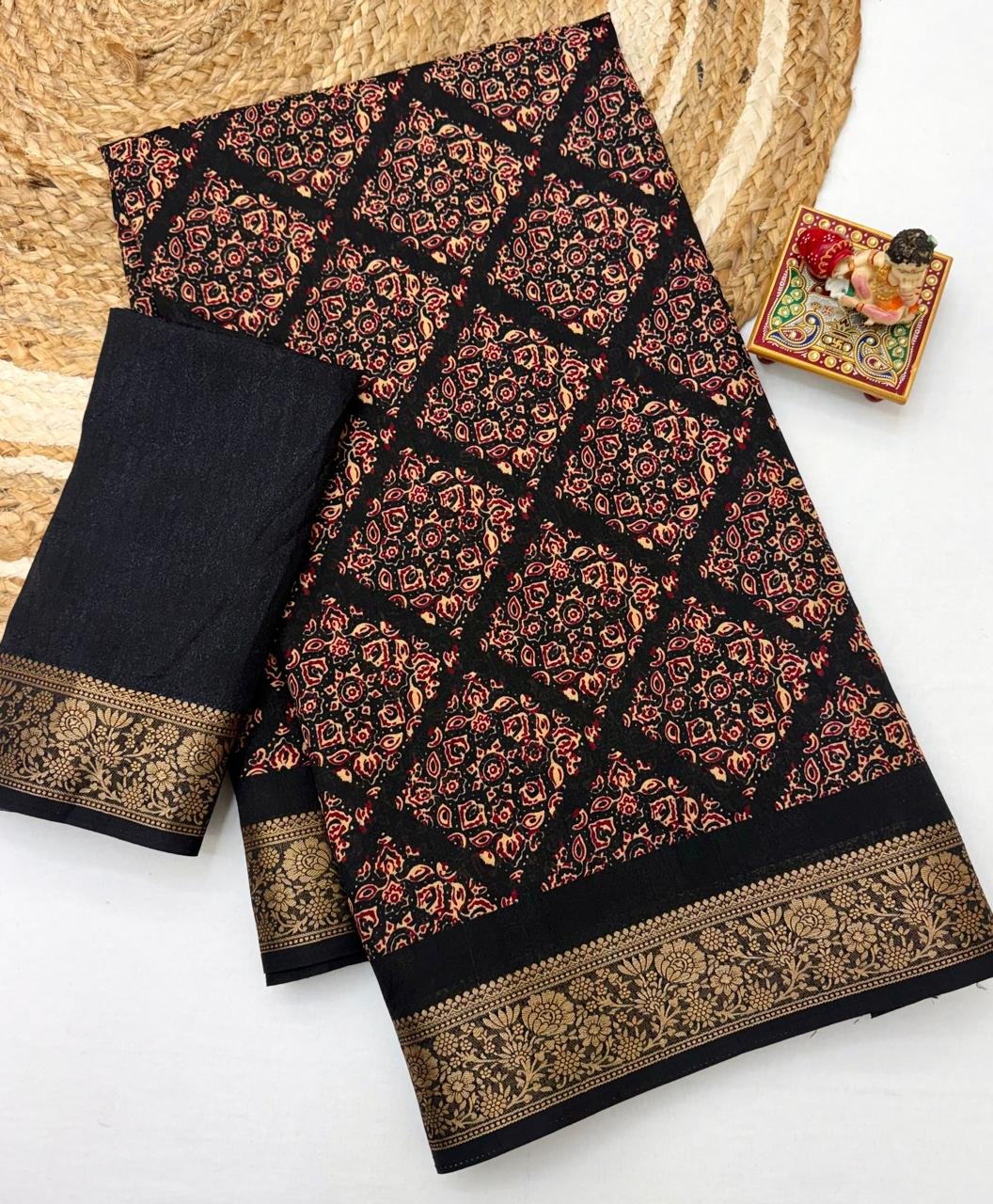 Soft Dola Weaving Saree with Jacquard Border 3 A navy blue Soft Dola weaving saree with an intricate golden jacquard border and a matching blouse piece on a jute mat.