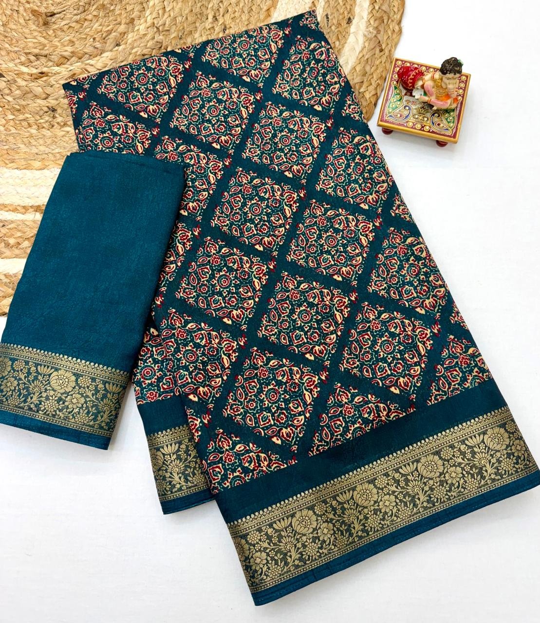 Soft Dola Weaving Saree with Jacquard Border 4 A navy blue Soft Dola weaving saree with an intricate golden jacquard border and a matching blouse piece on a jute mat.