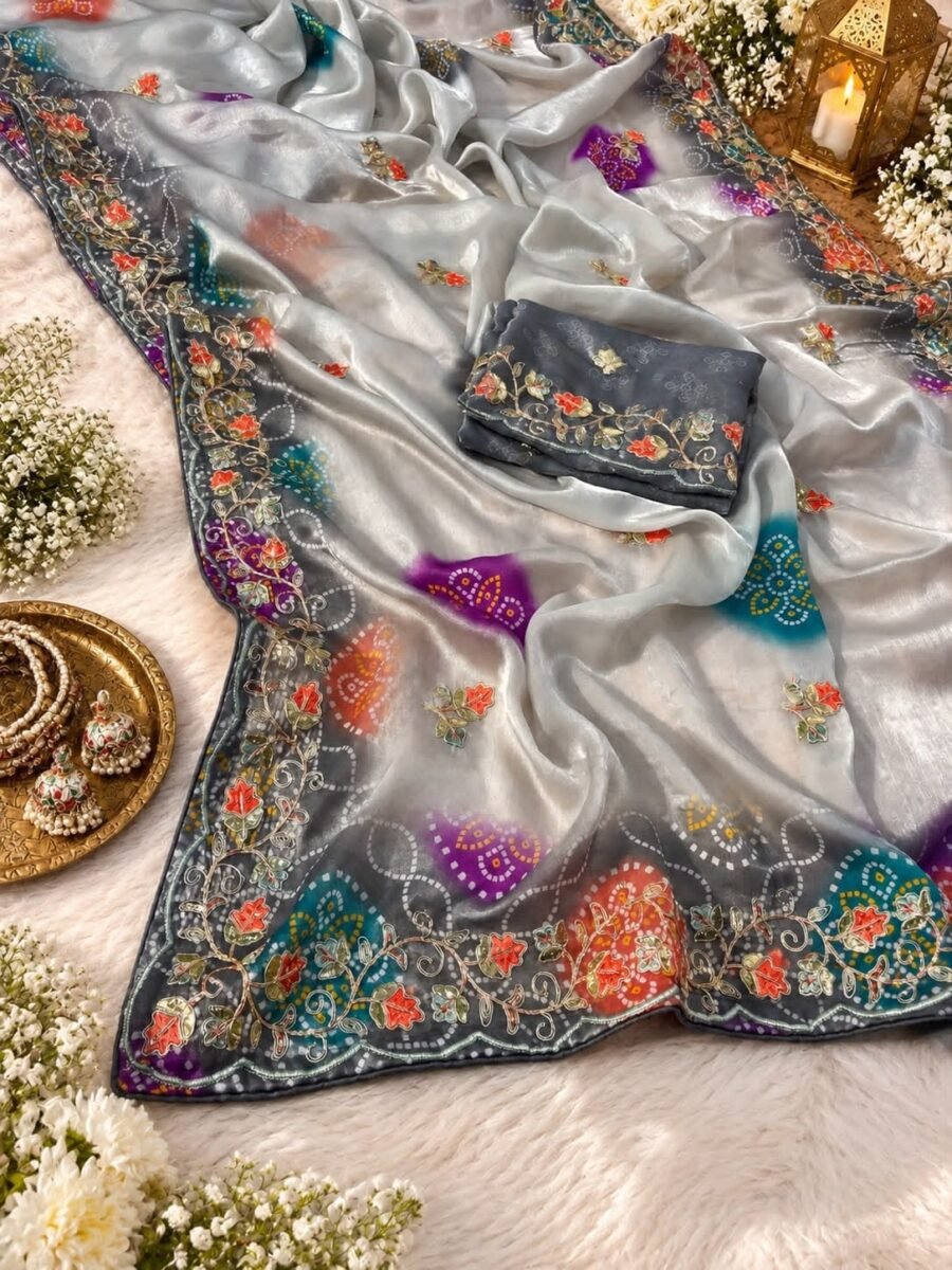 A beautiful silver space silk saree with colorful Bandhej prints and detailed gota foil embroidery on the border.
