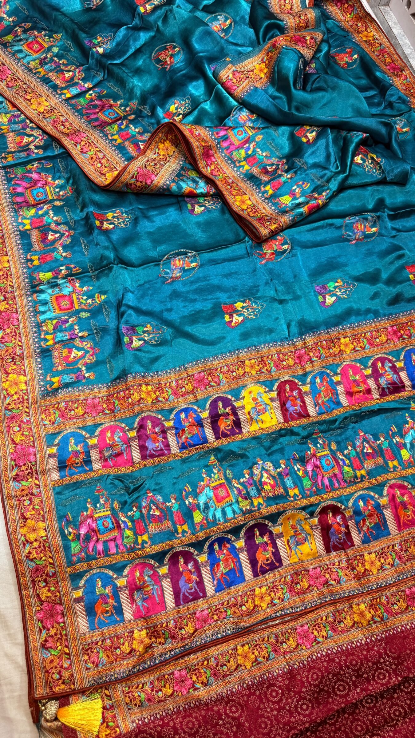 Royal Raj Darbari Tissue Silk Saree with Zari Work 1 A beautiful teal tissue silk saree featuring intricate golden zari work, traditional raj darbari motifs, and a matching embroidered blouse.