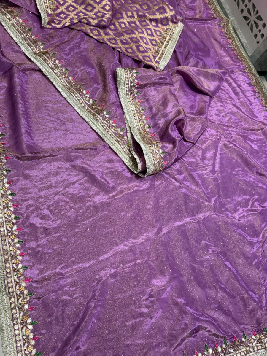 A beautiful purple Pure Tissue Cosmos Silk saree with heavy gold Gota Patti work and a traditional Kiran border.