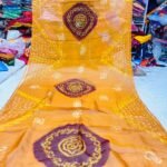 An Art Silk Bandhani saree displayed in yellow with prominent maroon circular Bandhej motifs.