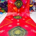 An Art Silk Bandhani saree displayed in yellow with prominent maroon circular Bandhej motifs.
