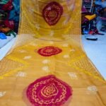 An Art Silk Bandhani saree displayed in yellow with prominent maroon circular Bandhej motifs.