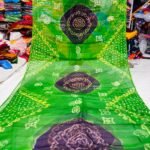 An Art Silk Bandhani saree displayed in yellow with prominent maroon circular Bandhej motifs.