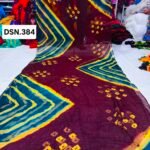 A person holding up a vibrant art silk Bandhani saree with geometric patterns and bright tie-dye work.