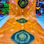 An Art Silk Bandhani saree displayed in yellow with prominent maroon circular Bandhej motifs.