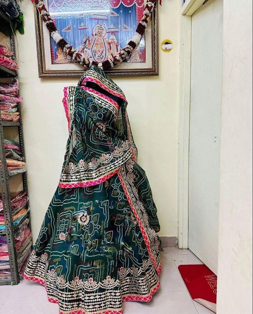 Bandhani Lehenga, Kota Doria Bandhani Lehenga with Gota Patti 2 A red and yellow Bandhani lehenga with Gota Patti work displayed on a mannequin.