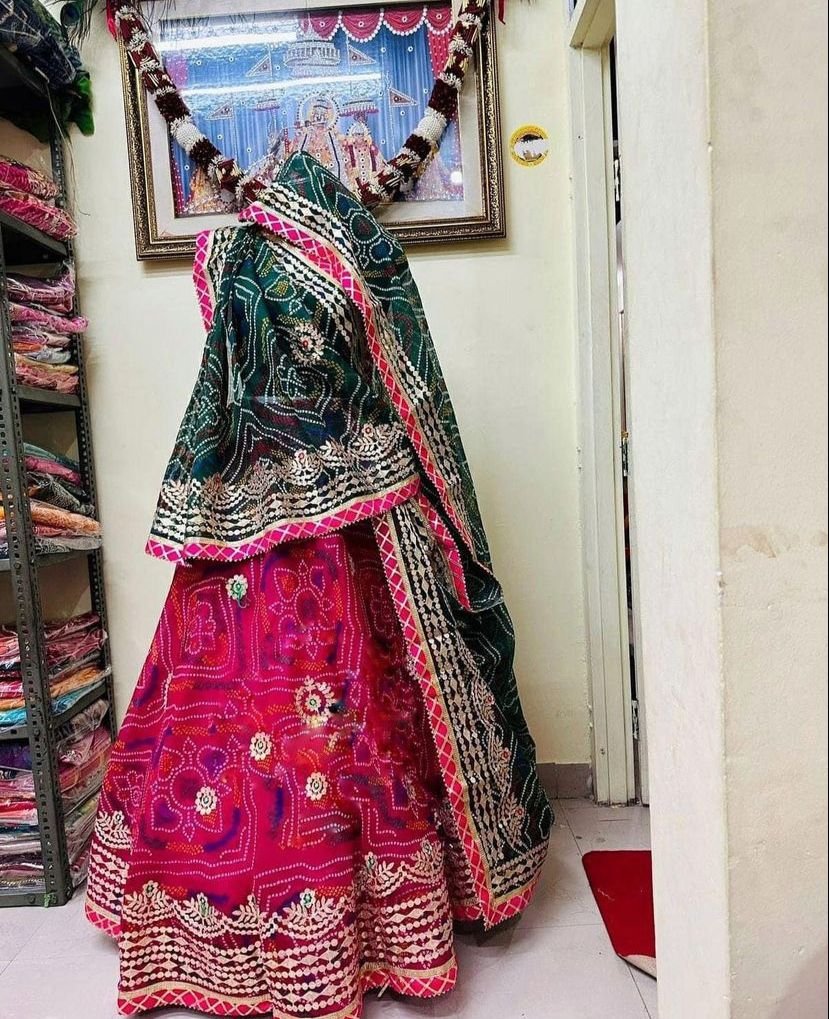 Bandhani Lehenga, Kota Doria Bandhani Lehenga with Gota Patti 5 A red and yellow Bandhani lehenga with Gota Patti work displayed on a mannequin.