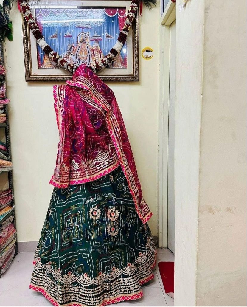 Bandhani Lehenga, Kota Doria Bandhani Lehenga with Gota Patti 6 A red and yellow Bandhani lehenga with Gota Patti work displayed on a mannequin.