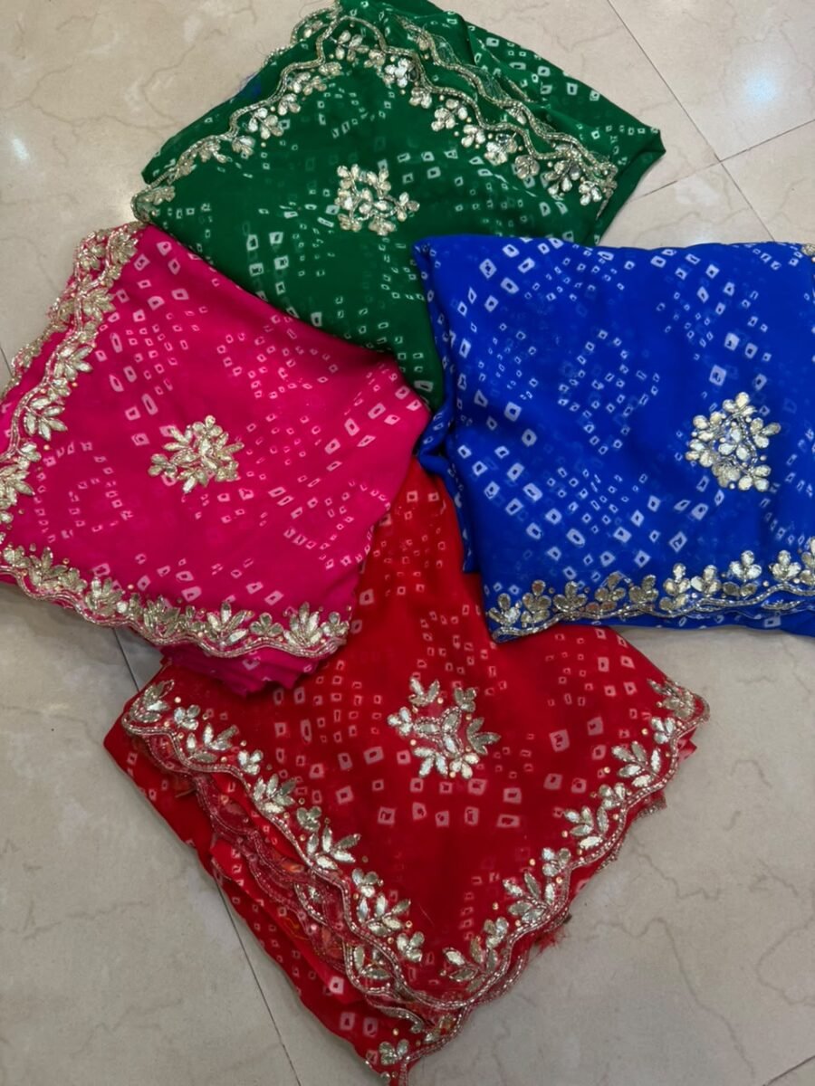 Four vibrant Bandhej sarees in red, pink, blue, and green with heavy Gota Patti borders lying on a floor.