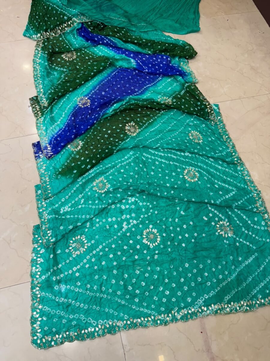 A beautiful semi silk Bandhej saree in shades of green and blue, featuring intricate Gota Patti and Katdana handwork throughout the fabric.
