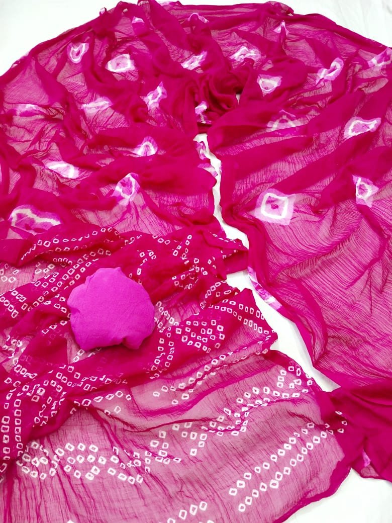 Nazneen Chiffon Bandhani Saree 5 A vibrant red Nazneen chiffon Bandhani saree displayed with a matching pink blouse piece.
