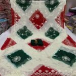 A beautiful half pure chiffon saree with green and magenta diamond patterns and intricate silver gota patti embroidery.