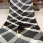 A beautiful blue and white double color Leheriya saree made of najmeen chiffon fabric with a gold piping border.