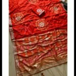 Four folded Dola Viscose Bandhej sarees in vibrant colours featuring intricate Gota Patti borders and rich weaving.