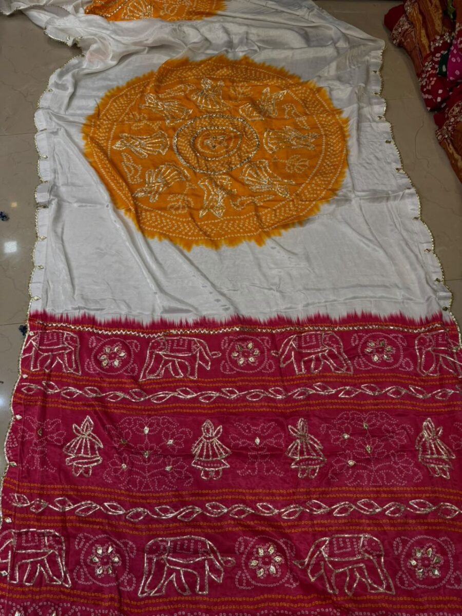 A beautiful white and yellow Bandhej saree with a vibrant pink border featuring Gota Patti elephant and doll motifs.