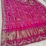A red pure Gajji silk Bandhej dupatta with gold zari checks, heavy gota patti border, and a rich zari pallu.