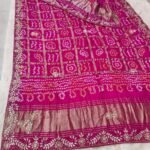 A red pure Gajji silk Bandhej dupatta with gold zari checks, heavy gota patti border, and a rich zari pallu.